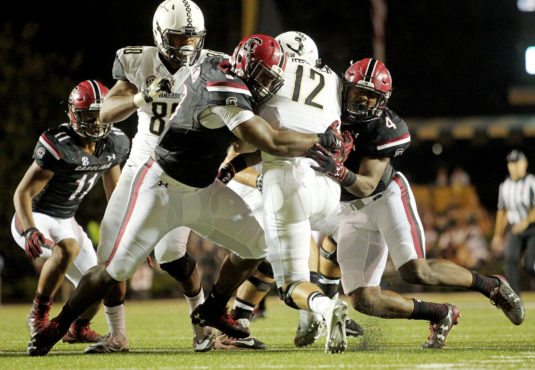 South Carolina's Marquavius Lewis, left, and Bryson Allen-Williams wrap up Vanderbilt's Wade Freebeck during second-quarter action in Nashville, Tenn. on Thursday, Sept. 1, 2016. (Travis Bell/SIDELINE CAROLINA)